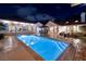 Inviting backyard featuring a sparkling pool, patio seating, and lush landscaping, perfect for relaxing evenings at 3240 W Richmar Ave, Las Vegas, NV 89139