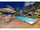 The backyard boasts a refreshing pool and shaded patio with comfortable seating for outdoor dining at 3240 W Richmar Ave, Las Vegas, NV 89139