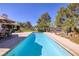 Relaxing backyard pool with ample space, green grass, and patio area for outdoor living at 3240 W Richmar Ave, Las Vegas, NV 89139
