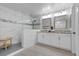 Modern bathroom featuring a glass-enclosed shower, dual sinks, and sleek white cabinetry at 3268 Grayson Lake Ct, Las Vegas, NV 89129