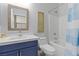 Well-lit bathroom featuring a vanity, mirror, toilet and shower/tub combo with blue and white striped shower curtain at 3268 Grayson Lake Ct, Las Vegas, NV 89129