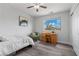 Comfortable bedroom features a ceiling fan, desk, chair, closet and bright natural light from the window at 3268 Grayson Lake Ct, Las Vegas, NV 89129