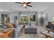 Bright living room featuring a comfortable gray sectional, stylish decor, and plenty of natural light at 3268 Grayson Lake Ct, Las Vegas, NV 89129