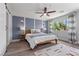 Main bedroom features ceiling fan, wood-like floors, and a large window providing great light at 3268 Grayson Lake Ct, Las Vegas, NV 89129