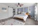 Main bedroom features a ceiling fan, wood-like floors, and a sliding barn door to main bath at 3268 Grayson Lake Ct, Las Vegas, NV 89129