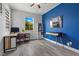Bright office space features a blue accent wall, large window and wood grain flooring at 3268 Grayson Lake Ct, Las Vegas, NV 89129