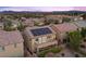 Aerial view of the back of the home with solar panels, a balcony, patio and lush landscaping at 3268 Grayson Lake Ct, Las Vegas, NV 89129