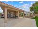 Inviting covered back patio with fan, with outdoor seating next to a hot tub and beautifully landscaped yard at 36 Trailside Ct, Henderson, NV 89012