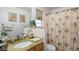 Well-lit bathroom with granite counter, floral shower curtain, and decorative accents at 36 Trailside Ct, Henderson, NV 89012