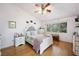 Bright bedroom with ceiling fan, wood floors and a large window at 36 Trailside Ct, Henderson, NV 89012