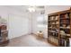 Bright bedroom features a ceiling fan, bookshelf, and sliding door closet at 36 Trailside Ct, Henderson, NV 89012