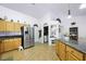 Open kitchen with stainless steel appliances and adjacent laundry area at 36 Trailside Ct, Henderson, NV 89012