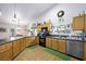 Open kitchen with wooden cabinets and black appliances at 36 Trailside Ct, Henderson, NV 89012