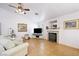 Cozy living room featuring tile floors, a fireplace, and a large television at 36 Trailside Ct, Henderson, NV 89012