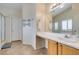 Bathroom featuring a vanity with sink and lots of counter space, next to a glass enclosed shower at 4417 Gracemont Ave, Las Vegas, NV 89139