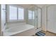 Bright bathroom with separate tub and shower and large window with plantation shutters at 4417 Gracemont Ave, Las Vegas, NV 89139