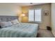 Neutral bedroom featuring a bed, carpet flooring, and a window with plantation shutters at 4417 Gracemont Ave, Las Vegas, NV 89139