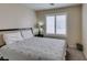 Bedroom features a bed with a patterned comforter, plush pillows, and a window with shutters at 4417 Gracemont Ave, Las Vegas, NV 89139