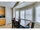 Bright breakfast nook with dark wood table, cabinets, and plantation shutters at 4417 Gracemont Ave, Las Vegas, NV 89139