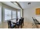 Bright dining area with dark wood table set and plantation shutters at 4417 Gracemont Ave, Las Vegas, NV 89139