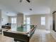 This game room features a billiard table, large windows with plantation shutters, and tiled floors at 4417 Gracemont Ave, Las Vegas, NV 89139