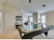 Well lit game room with a ceiling fan, a billiard table, and a glimpse of the living room beyond at 4417 Gracemont Ave, Las Vegas, NV 89139