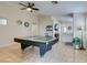 Spacious game room featuring tile flooring and a pool table under a ceiling fan at 4417 Gracemont Ave, Las Vegas, NV 89139