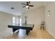 This game room features a ceiling fan, billiards table, and light tile flooring at 4417 Gracemont Ave, Las Vegas, NV 89139