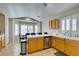Sunny kitchen with oak cabinets, stainless steel appliances, and a dining nook at 4417 Gracemont Ave, Las Vegas, NV 89139