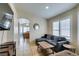 Comfortable living room with a gray sectional couch and shuttered windows at 4417 Gracemont Ave, Las Vegas, NV 89139