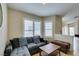 Bright and cozy living room with a gray sectional couch and shuttered windows at 4417 Gracemont Ave, Las Vegas, NV 89139