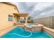 A backyard pool and spa, with an adjacent covered patio and lush landscaping at 4417 Gracemont Ave, Las Vegas, NV 89139