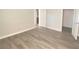 Spacious bedroom featuring new gray wood-look flooring and white baseboards at 5055 W Hacienda Ave # 2055, Las Vegas, NV 89118