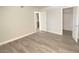 Spacious bedroom featuring new gray wood-look flooring and white baseboards at 5055 W Hacienda Ave # 2055, Las Vegas, NV 89118