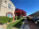 Condo building exterior showcasing well-manicured landscaping at 5055 W Hacienda Ave # 2055, Las Vegas, NV 89118