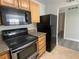 Updated kitchen featuring stainless steel appliances, granite countertops, and wood cabinets at 5055 W Hacienda Ave # 2055, Las Vegas, NV 89118