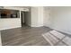 Living space with wood-look flooring and kitchen peek-through at 5055 W Hacienda Ave # 2055, Las Vegas, NV 89118