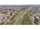 Scenic aerial view of a community with an adjacent golf course at 5328 Walton Heath Ave, Las Vegas, NV 89142