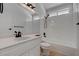 Modern bathroom with vanity, shower, tile flooring, and a window at 5328 Walton Heath Ave, Las Vegas, NV 89142