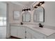 Bathroom featuring a dual sink vanity with white cabinets and modern black fixtures at 5328 Walton Heath Ave, Las Vegas, NV 89142