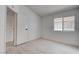 Cozy bedroom offers lots of natural light, wood-look flooring, and a window at 5328 Walton Heath Ave, Las Vegas, NV 89142