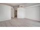 Spacious bedroom with light wood-look floors, multiple entryways, and neutral decor at 5328 Walton Heath Ave, Las Vegas, NV 89142