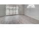 Bedroom with laminate floors and sliding glass doors leading to a covered outdoor patio at 5328 Walton Heath Ave, Las Vegas, NV 89142