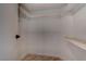 Walk-in closet with white walls, wood floor, shelf and clothing rack at 5328 Walton Heath Ave, Las Vegas, NV 89142