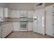 Bright kitchen features white appliances, tile floors and ample cabinet space at 5328 Walton Heath Ave, Las Vegas, NV 89142