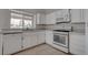 Bright kitchen featuring white cabinetry and modern appliances, complemented by a window over the sink at 5328 Walton Heath Ave, Las Vegas, NV 89142