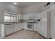 Well-lit kitchen with white appliances and cabinets, providing a clean and functional cooking space at 5328 Walton Heath Ave, Las Vegas, NV 89142