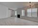 Bright living room featuring new wood flooring, modern lighting, and a fireplace at 5328 Walton Heath Ave, Las Vegas, NV 89142