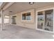 Comfortable covered patio with concrete floor, recessed lighting and backyard access at 5328 Walton Heath Ave, Las Vegas, NV 89142