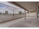 Covered patio with concrete floor, white brick perimeter and metal fencing at 5328 Walton Heath Ave, Las Vegas, NV 89142